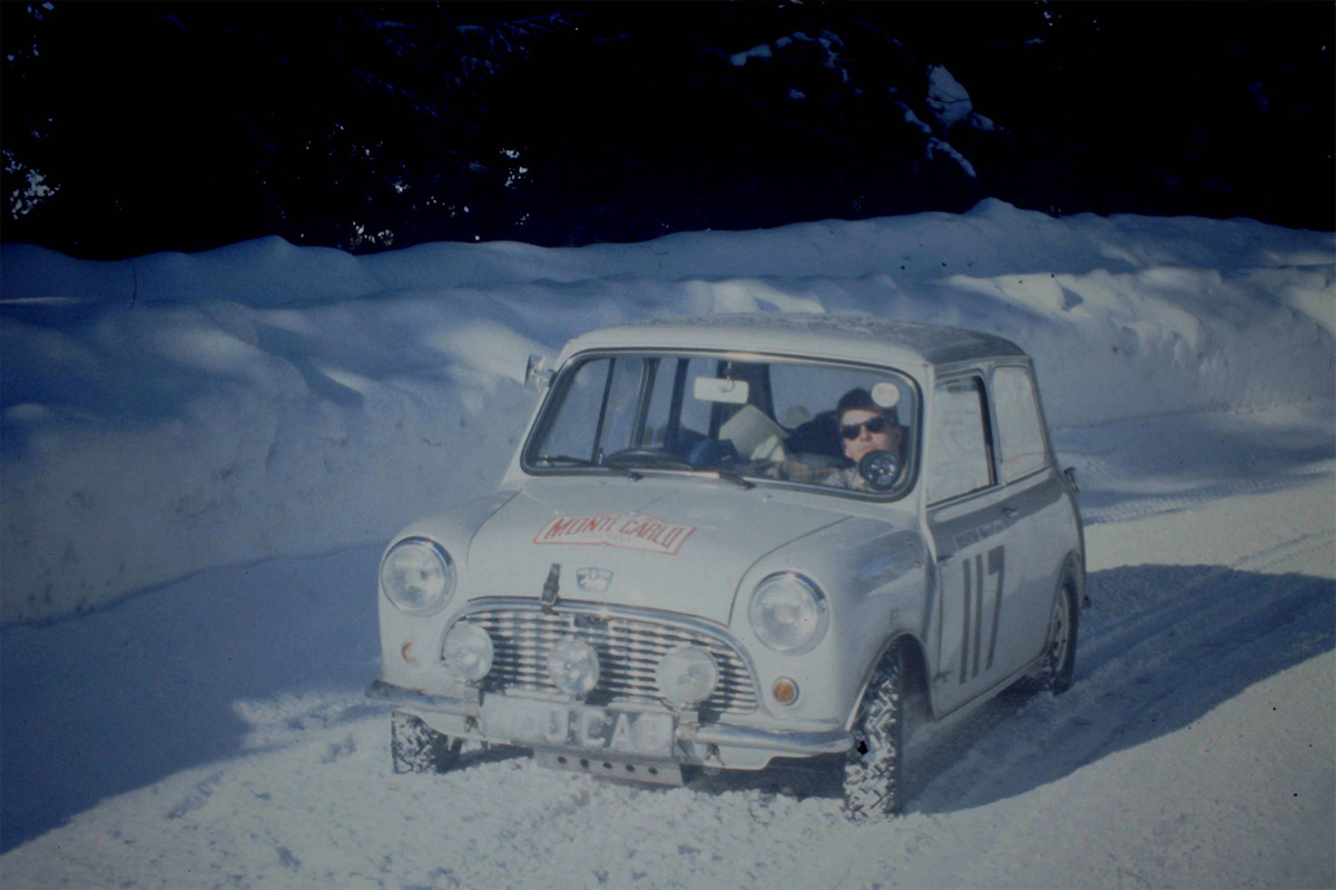 Mini Cooper driving through the snow.